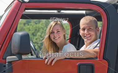 Couple in Red Jeep Stock Photo