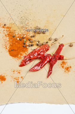 Dried Peppers And Other Kind Of Peppers Spices On A Brown Background Stock Photo