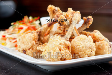 Fried Chicken Wings Garnished With Fresh Vegetables With Teriyaki Sauce Stock Photo