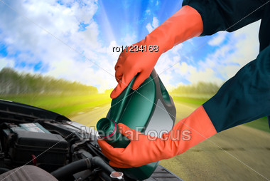 Man Pours Motor Oil Into The Engine Stock Photo