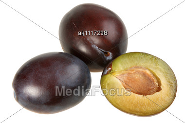 Three Dark-purple Plums. Close-up Stock Photo