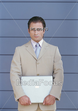 Young Business Man Holding Laptop Stock Photo