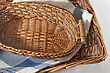 Brown Wicker Basket With A Blue Gingham Cloth For Table Appointments - stock photography