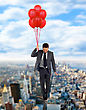Stock Photo : Success Stock Photo: Businessman Flying High With Helium Balloons.