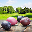 Colored Easter Eggs On A Wooden Table In A Landscape - stock image