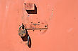 Stock Photo : Security Stock Photography: Rusty Padlock On The Red Metal Door