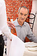Senior Man Drinking Wine In A Restaurant