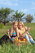 Stock Photo : Basket Pictures: Two Attractive Blonde With Wineglasses Sitting On A Grass