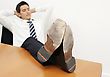 Young Man Leaning Back At His Desk Relaxing