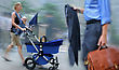 Young Parent With Stroller Rushing On The Street In Intentional Motion Blur, Businessman Walking By