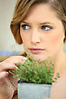 Stock Photo : Herb Stock Image: Young Woman Picking Herbs From A Pot